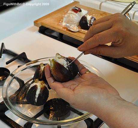 Gently cleaning Chevre-stuffed figs with edge of butter knife