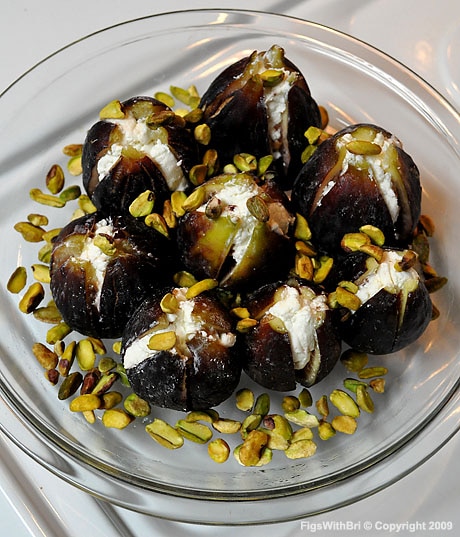 Chevre goat cheese-stuffed Black Mission figs with raw Pistachios ready for roasting