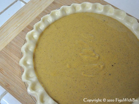 pumpkin pie filling poured in crust before baking