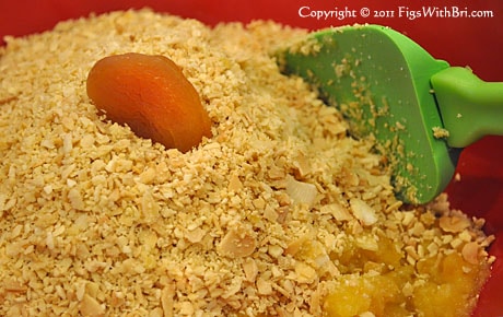 apricot on pile of chopped almonds and apple puree