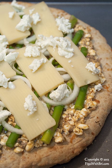 creamy goat cheese chevre accents a homemade pizza