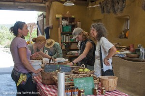 shoppers visiting at small farm market in barn